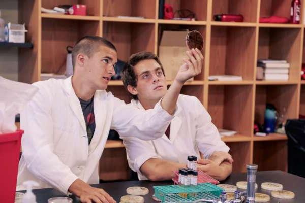 Two students looking at a petri dish